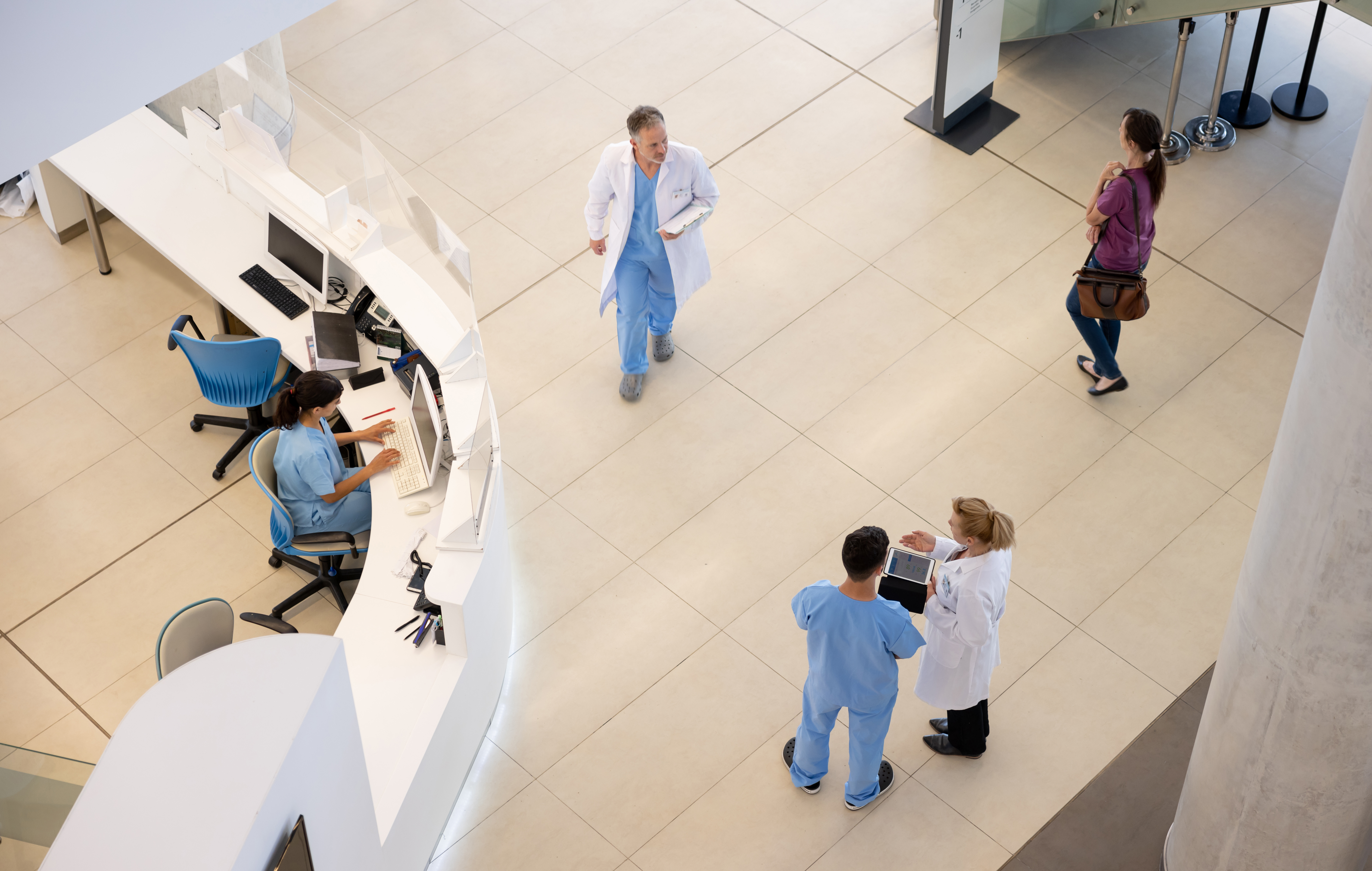 Hospital staff on a busy floor.